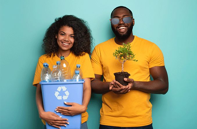 man and woman holding recyclables and a plant (sustainable materials) wearing sunglasses